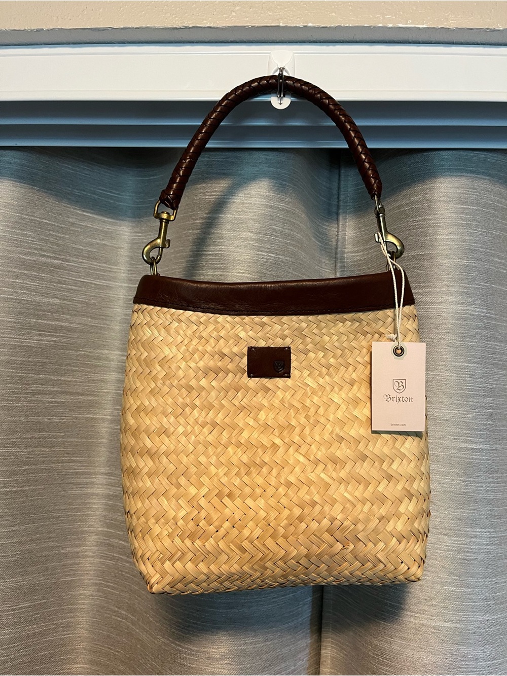 Brixton Tan Straw Bag with Brown Trim and braided leather handle.